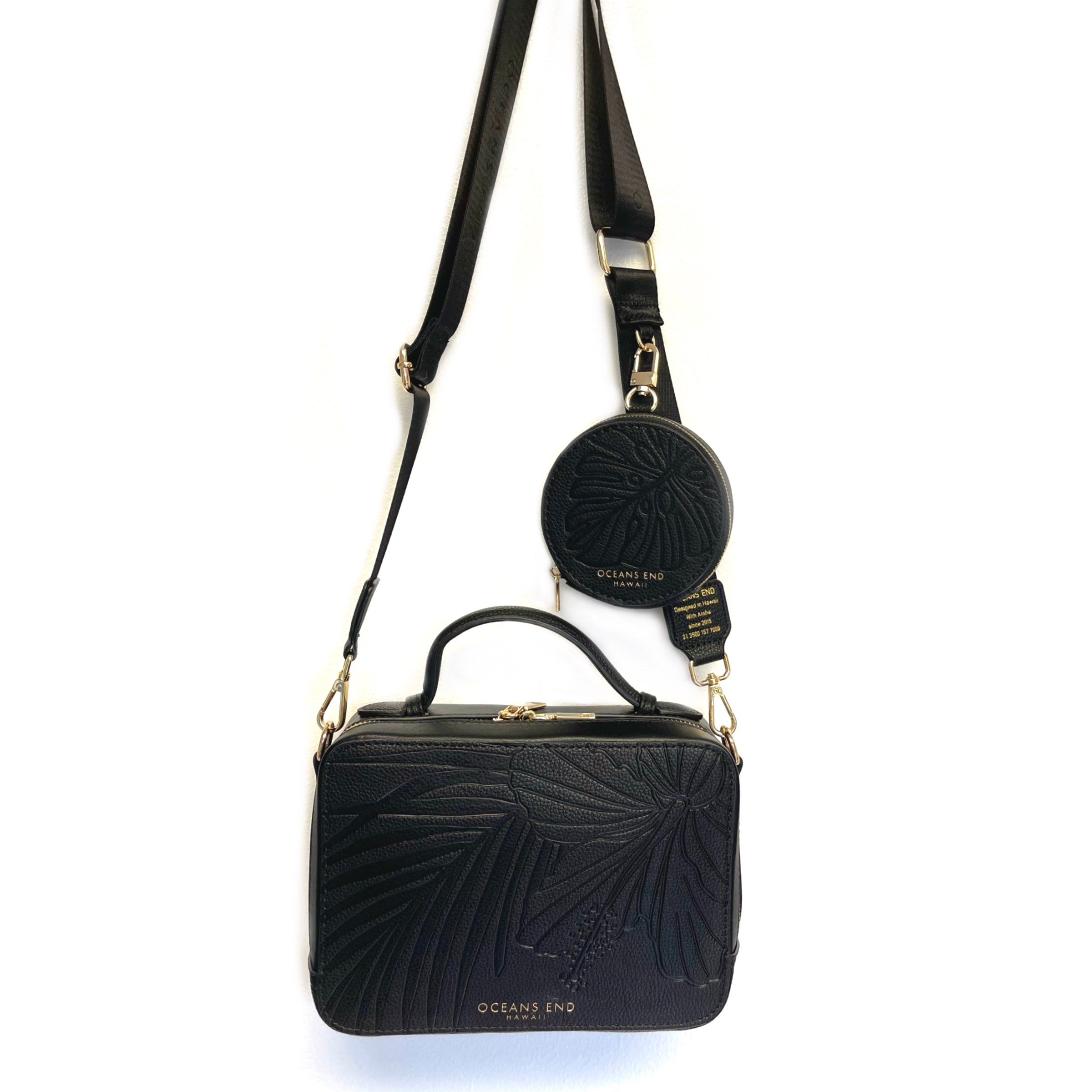 Black crossbody camera bag with tropical flower embossed on vegan leather paired with the Luxury Strap in Onyx- Oceans End