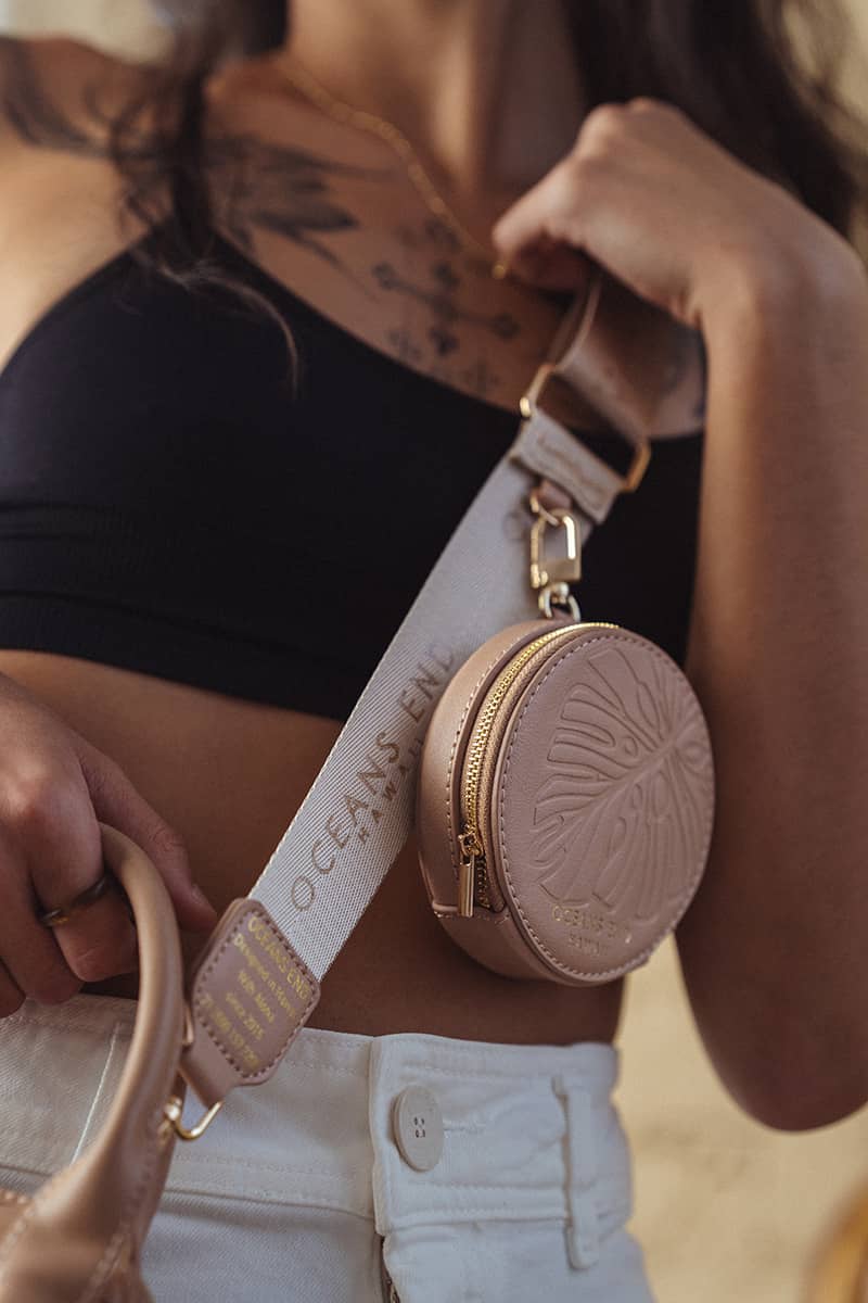 Luxury Strap with round zippered pouch in blush clipped on to vegan crossbody bag by Oceans End